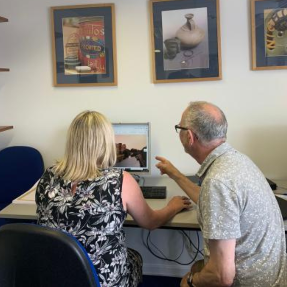 two research volunteers, a man and a woman, looking at the computer