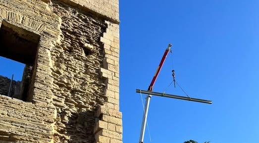 Crane lifting steel beams into place on the first floor of Newark Castle Gatehouse during restoration work.