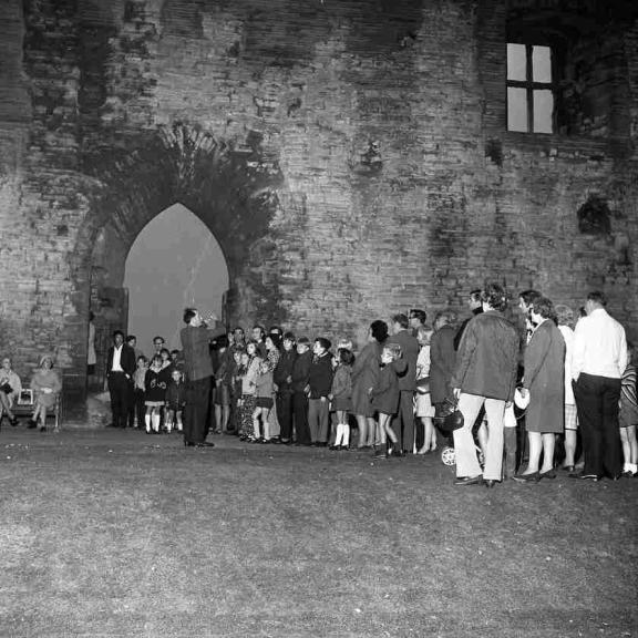 Black and white picture of people outside the castle in 1971 for the opening of the dungeon