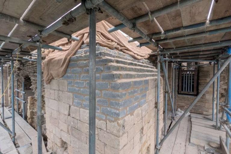 New stepped blue‑grey limestone courses forming the Gatehouse viewing platform, integrated into the historic stonework.