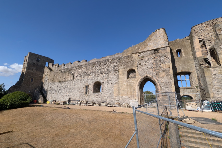Castle ruin wall with Heras fencing in front
