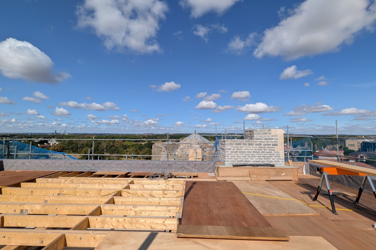 Wooden roof under construction with views over countryside