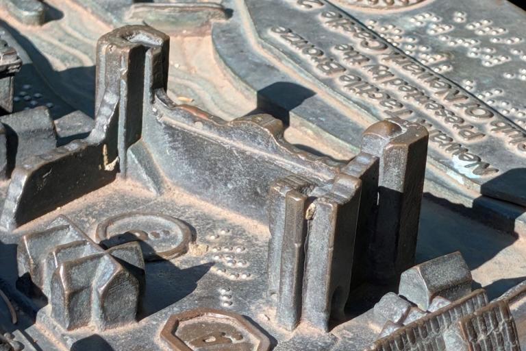 Bronze tactile map with raised features, braille and engraved text.