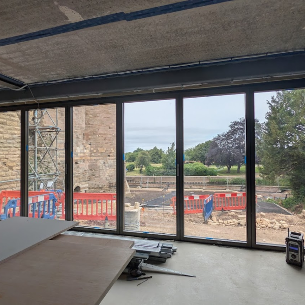 a view from inside new garden room looking towards river through large bifold doors