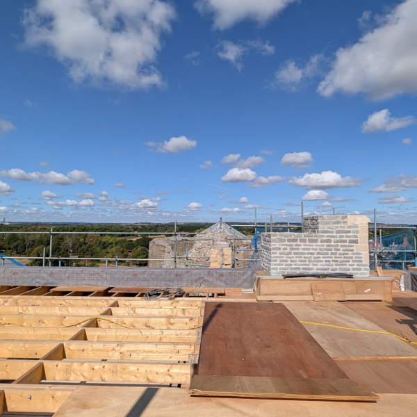 Wooden roof under construction with views over countryside